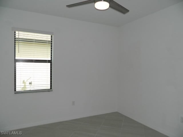 tiled empty room with ceiling fan