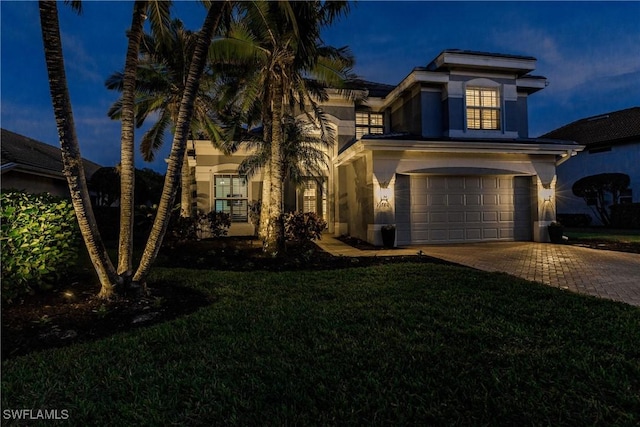 view of front of property with a front yard and a garage