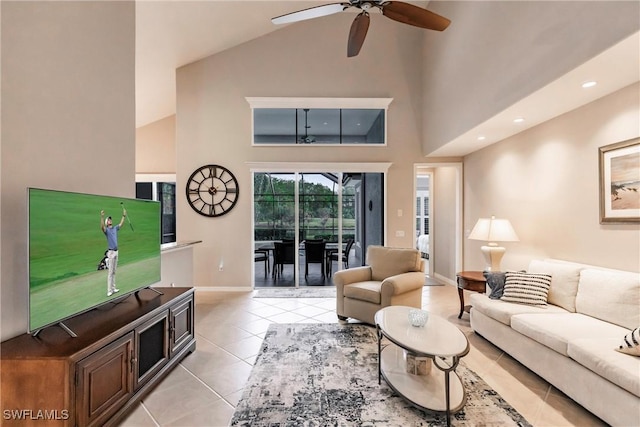 tiled living room with ceiling fan and high vaulted ceiling