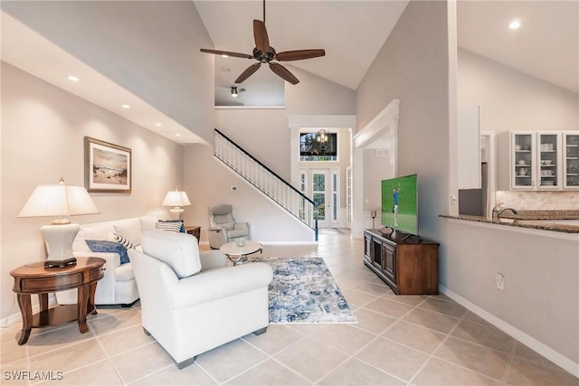 living room featuring ceiling fan, light tile patterned flooring, and high vaulted ceiling