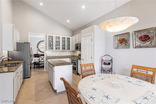 kitchen with white cabinets, sink, stainless steel appliances, and hanging light fixtures