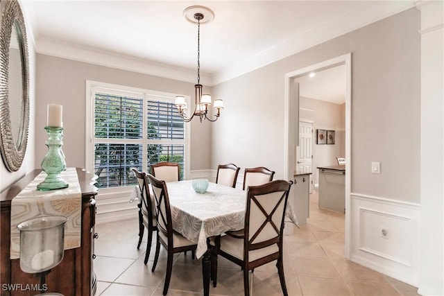 dining area featuring a chandelier, light tile patterned floors, and crown molding