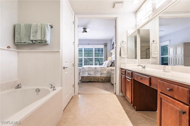 bathroom with vanity, a tub to relax in, tile patterned floors, and ceiling fan