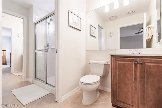 bathroom featuring tile patterned floors, toilet, and walk in shower