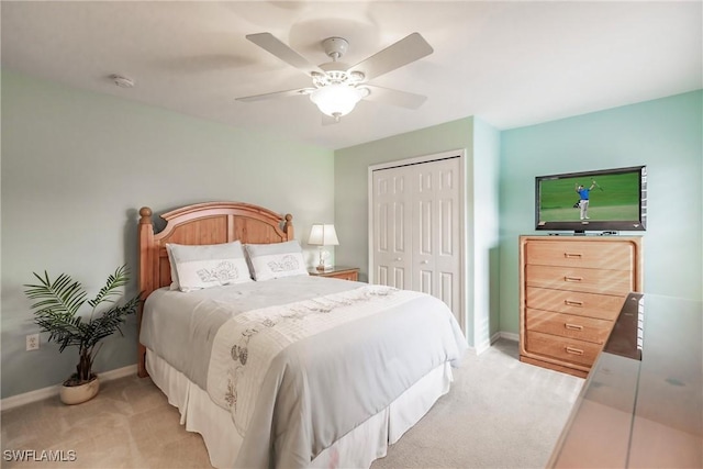 carpeted bedroom featuring a closet and ceiling fan