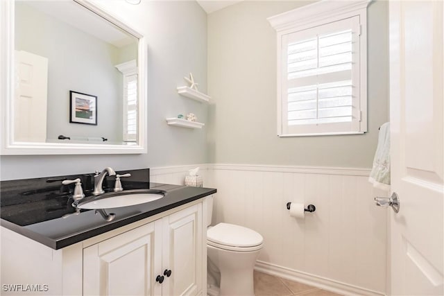 bathroom featuring tile patterned flooring, vanity, and toilet