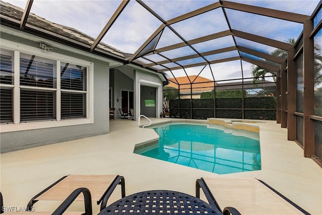 view of pool featuring glass enclosure and a patio