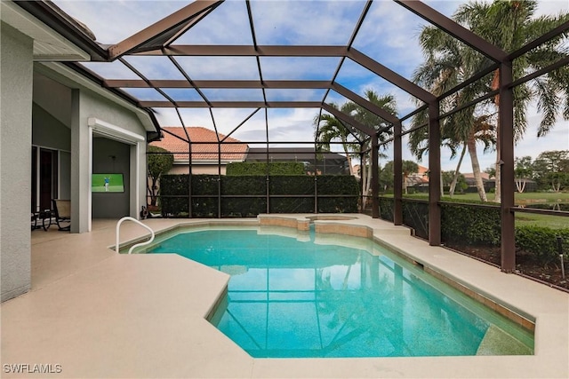 view of swimming pool with glass enclosure and a patio area