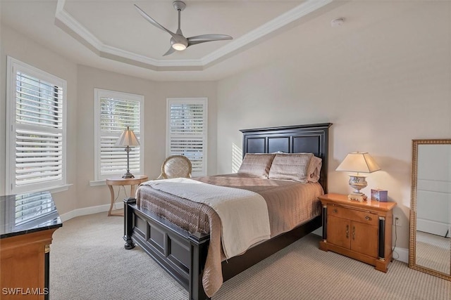 bedroom with a tray ceiling, ceiling fan, and carpet floors