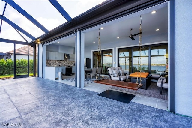 view of patio / terrace featuring glass enclosure and ceiling fan