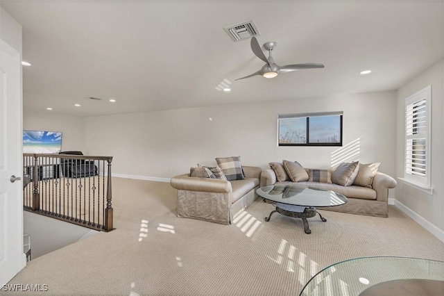 living room featuring ceiling fan and light colored carpet