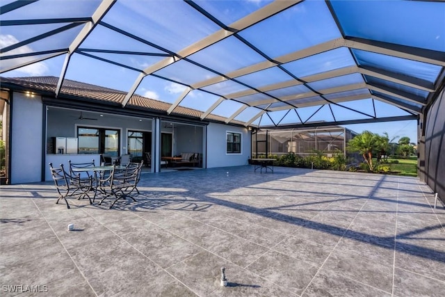 view of patio with glass enclosure and ceiling fan