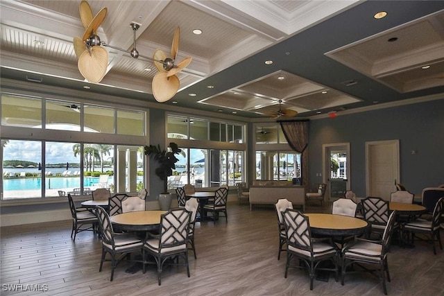 dining area with ceiling fan, beam ceiling, crown molding, and coffered ceiling