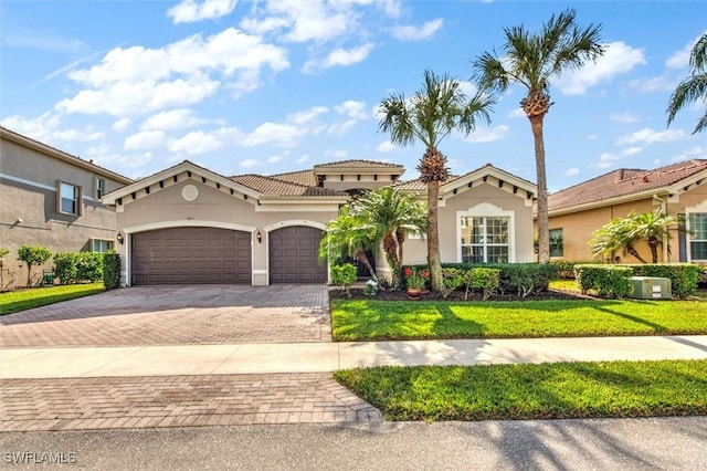 mediterranean / spanish-style house featuring a front lawn and a garage