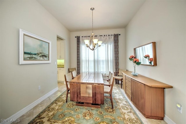 dining area with light tile patterned floors and a chandelier