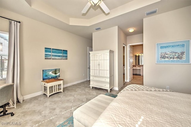 tiled bedroom with ceiling fan and a raised ceiling