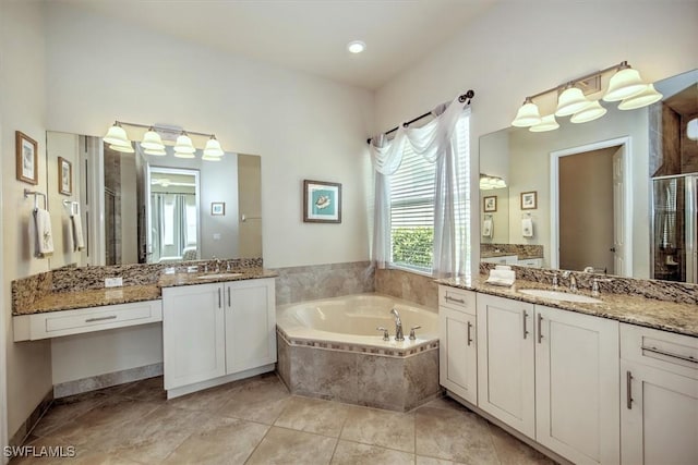 bathroom featuring tile patterned flooring, shower with separate bathtub, and vanity