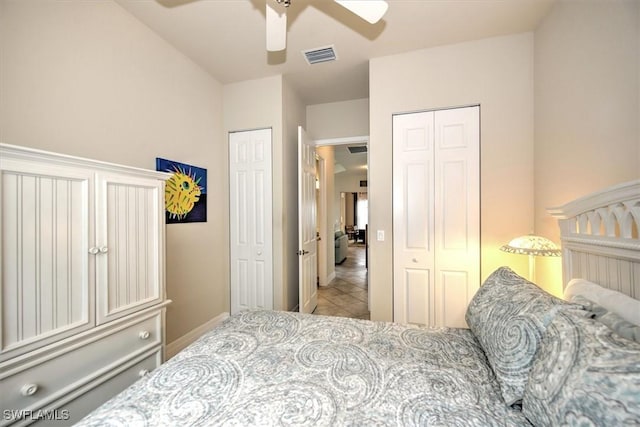 tiled bedroom featuring ceiling fan