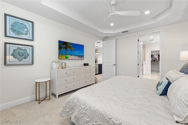 bedroom with recessed lighting, a raised ceiling, light colored carpet, visible vents, and baseboards