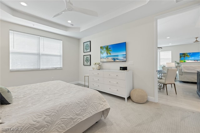 bedroom with baseboards, ceiling fan, a tray ceiling, and recessed lighting