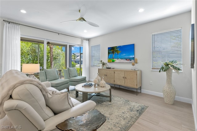 living room with ceiling fan, light wood finished floors, baseboards, and recessed lighting