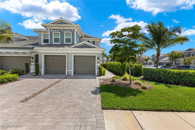 view of front facade featuring decorative driveway and an attached garage