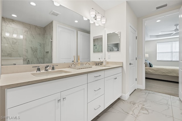 ensuite bathroom featuring marble finish floor, visible vents, a sink, and ensuite bath