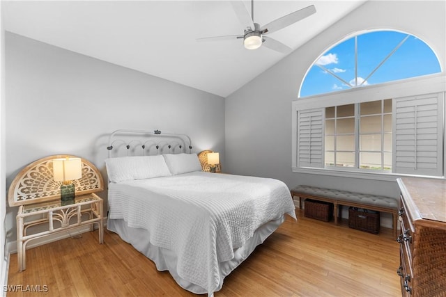 bedroom with ceiling fan, light hardwood / wood-style floors, multiple windows, and vaulted ceiling