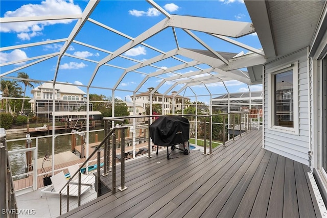 wooden terrace with area for grilling and glass enclosure