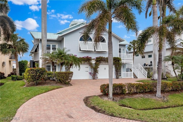 view of front of house featuring a garage and a front lawn