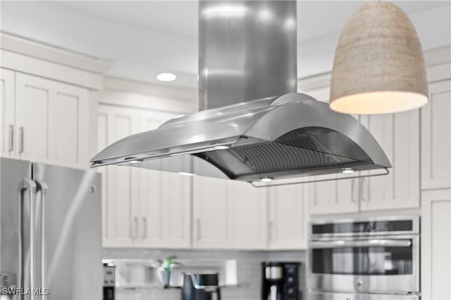 kitchen featuring island exhaust hood, white cabinets, and stainless steel appliances