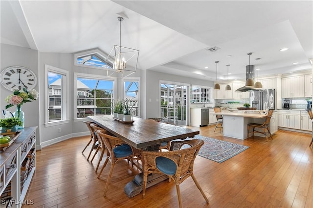 dining space featuring a chandelier and light wood-type flooring