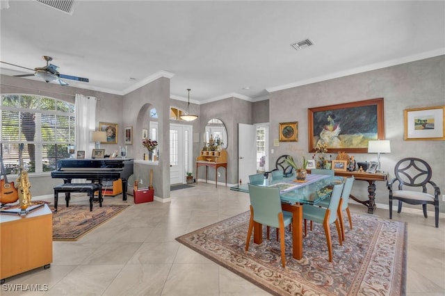 tiled dining room featuring ceiling fan and ornamental molding