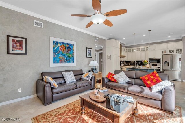 tiled living room with crown molding and ceiling fan