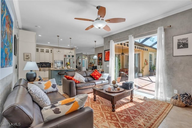 living room featuring ceiling fan and crown molding