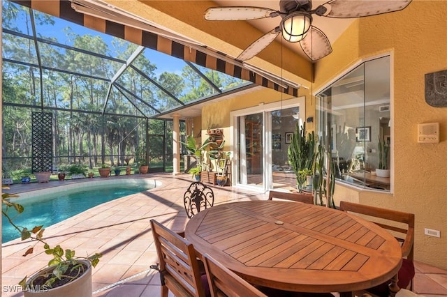 view of swimming pool featuring a lanai, a patio area, and ceiling fan