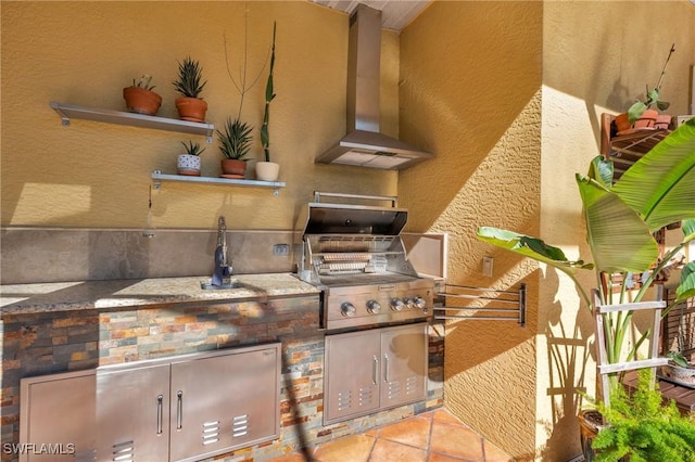 view of patio featuring exterior kitchen and a grill