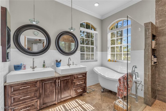 bathroom featuring tile walls, a tub to relax in, vanity, and ornamental molding