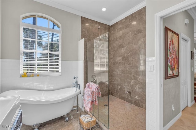 bathroom with tile patterned floors, tile walls, separate shower and tub, and crown molding