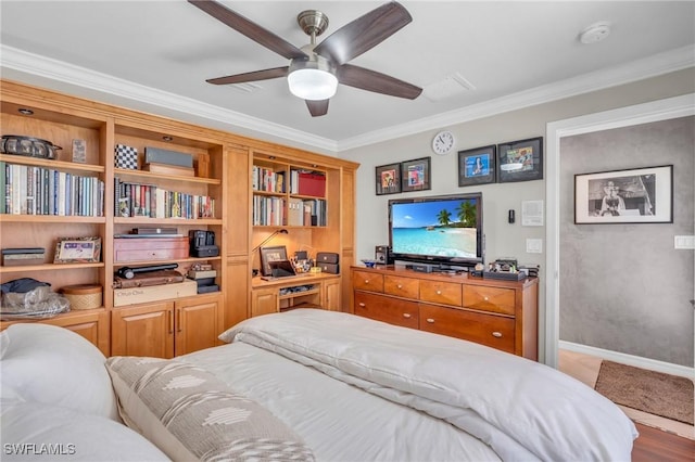 bedroom with ceiling fan, crown molding, and hardwood / wood-style flooring