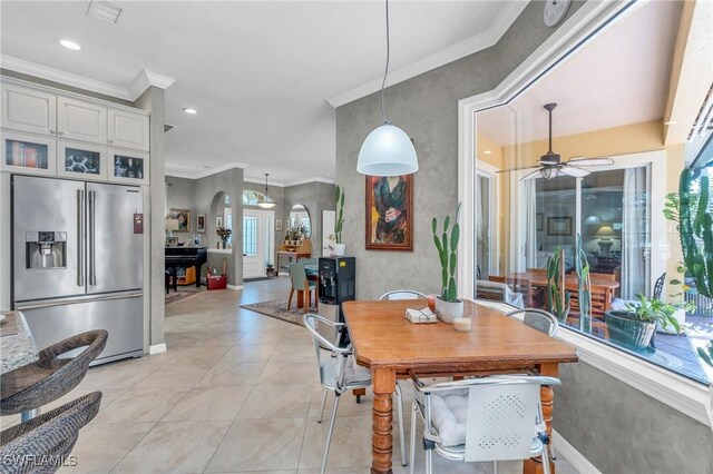 dining room with ceiling fan and crown molding