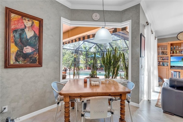 dining space with light tile patterned floors and ornamental molding