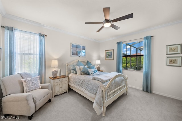 carpeted bedroom featuring ceiling fan and crown molding