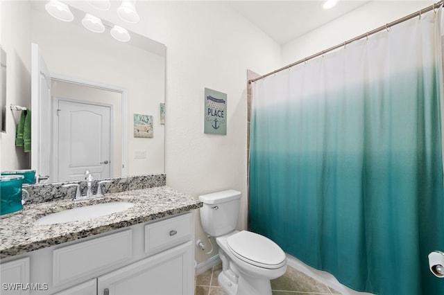 bathroom featuring tile patterned floors, vanity, and toilet