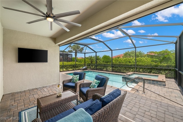 view of pool with an in ground hot tub, a patio, glass enclosure, and ceiling fan