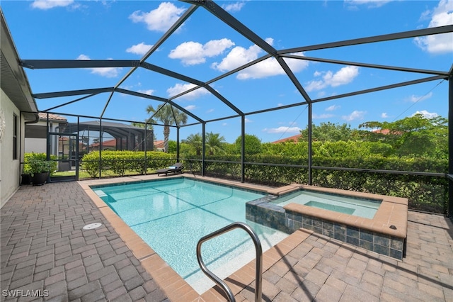 view of swimming pool featuring glass enclosure, an in ground hot tub, and a patio area