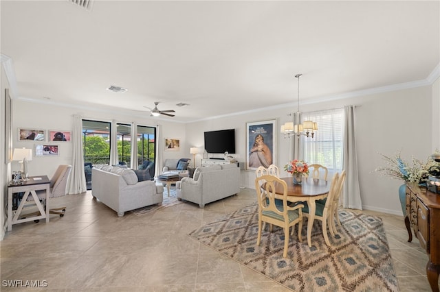 tiled dining space with ceiling fan with notable chandelier and crown molding