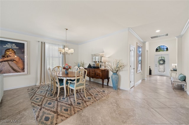 dining space featuring crown molding and a chandelier