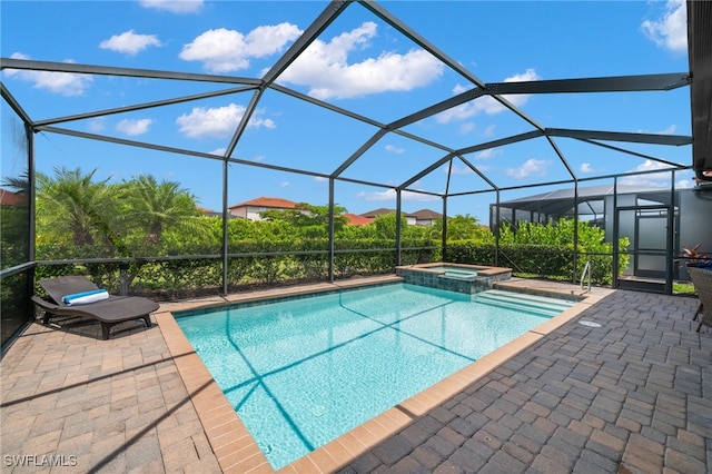 view of swimming pool featuring an in ground hot tub, a patio, and glass enclosure