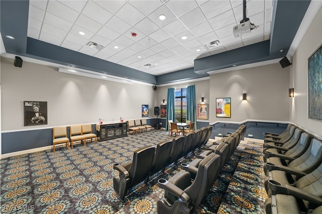 carpeted home theater with a paneled ceiling